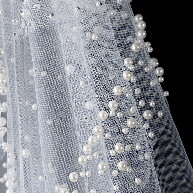 The Bridal Gown Features Round Pearl Embellishments Exuding A Vintage High-end Elegance photo 3