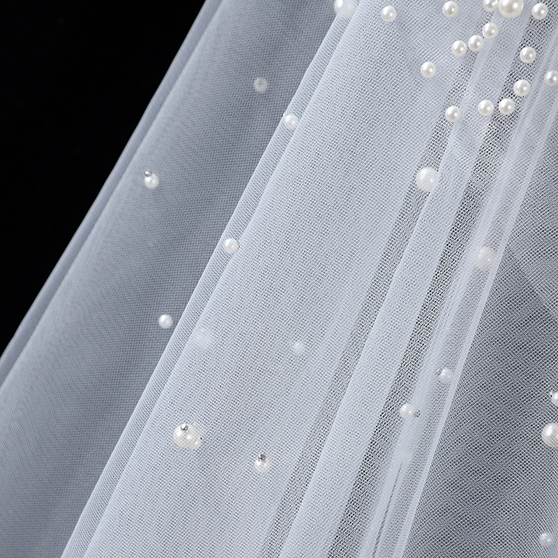 The Bridal Gown Features Round Pearl Embellishments Exuding A Vintage High-end Elegance photo 4
