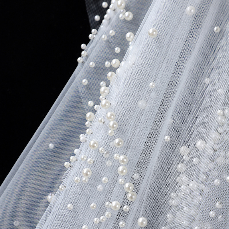 The Bridal Gown Features Round Pearl Embellishments Exuding A Vintage High-end Elegance photo 2